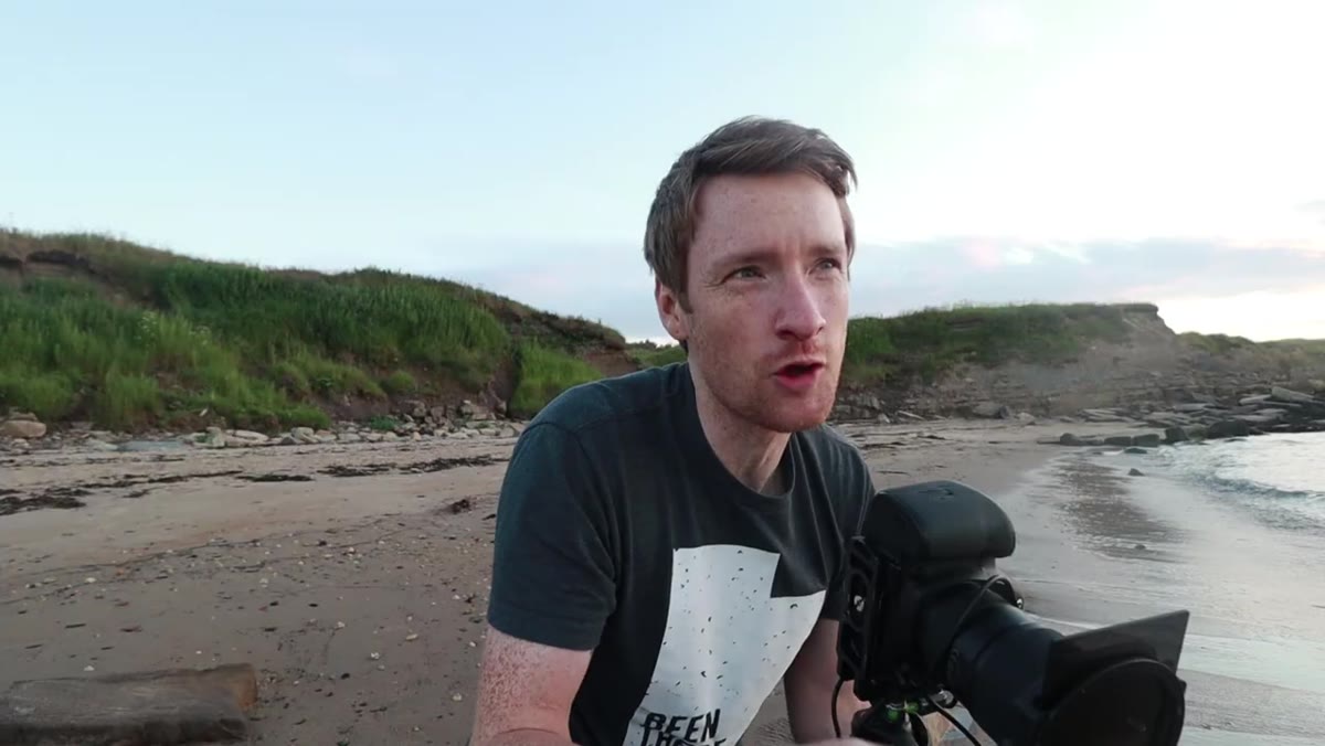 Thomas&rsquo;s tripod legs in wet sand near the water&rsquo;s edge