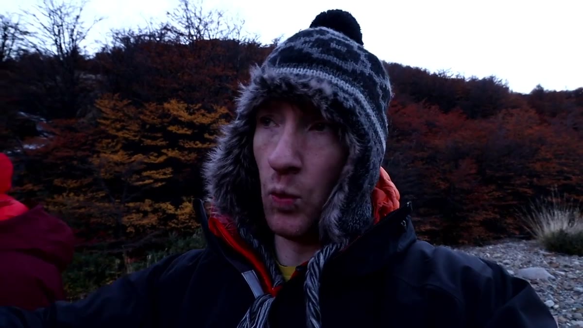 Thomas framing the shot beside a cascading waterfall