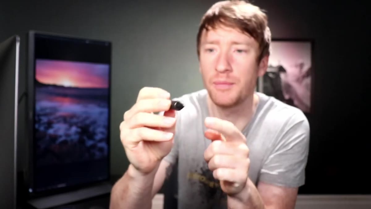 Heaton pointing to the two buttons on the pen itself