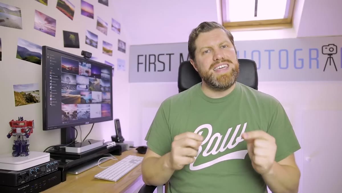 Adam at his desk discussing which version fits which photographer