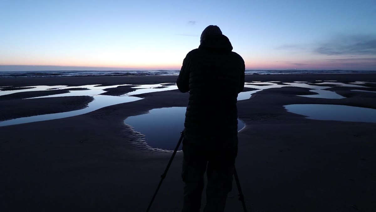 Heaton walking a beach transformed by recent storms